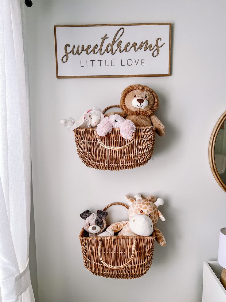 two baskets with stuffed animals are hanging on the wall