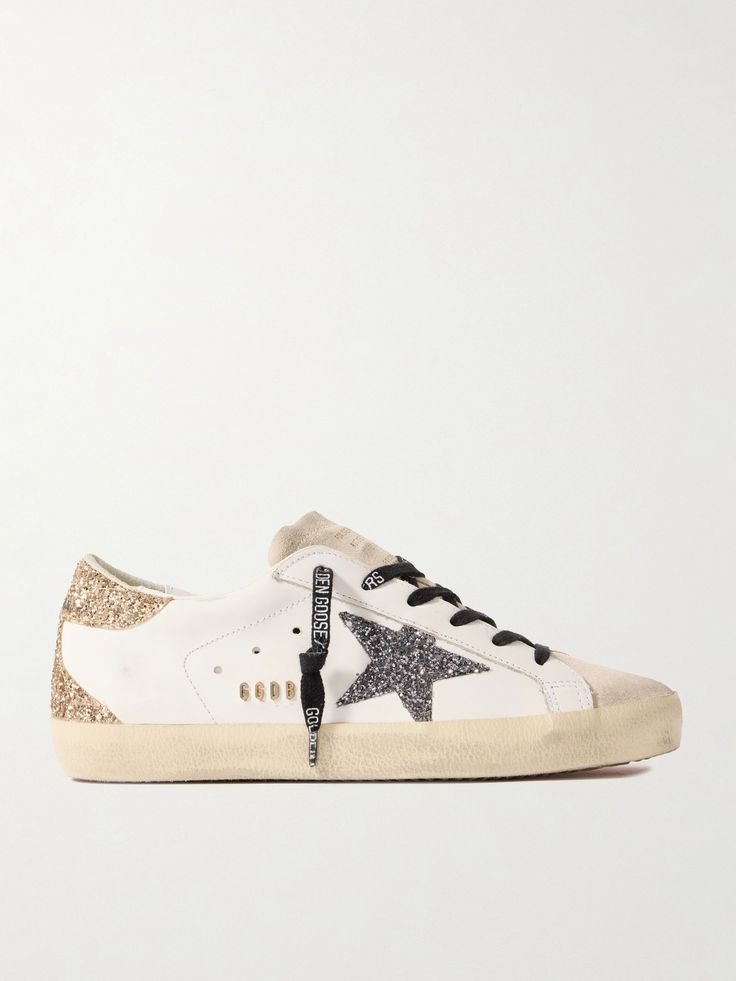 Golden Goose models its 'Super-Star' sneakers on classic skate styles and distresses them by hand to evoke the mood of authentically love-worn pairs. This iteration is made from supple leather and detailed with the label's star logo coated in light-catching glitter and a suede tongue. They'll go with almost everything in your wardrobe. Black And Gold Aesthetic, Golden Goose Superstar, Goose Sneakers, Stockholm Style, Skate Style, Golden Goose Sneakers, Golden Goose Deluxe Brand, Star Logo, Stockholm Fashion