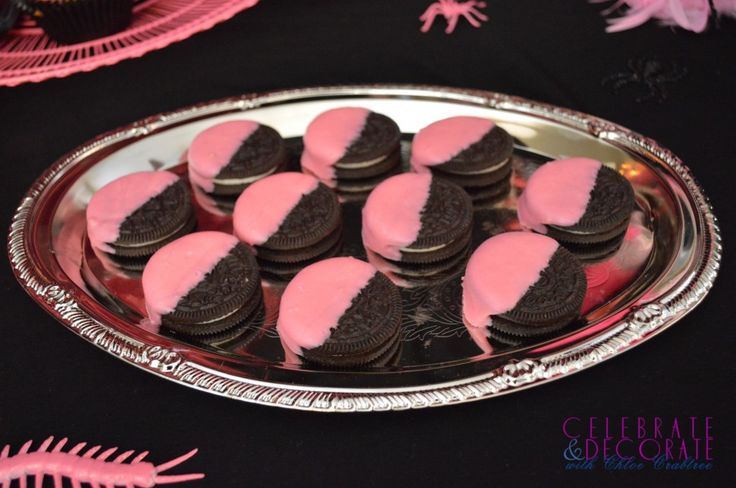 pink and black cupcakes on a silver platter