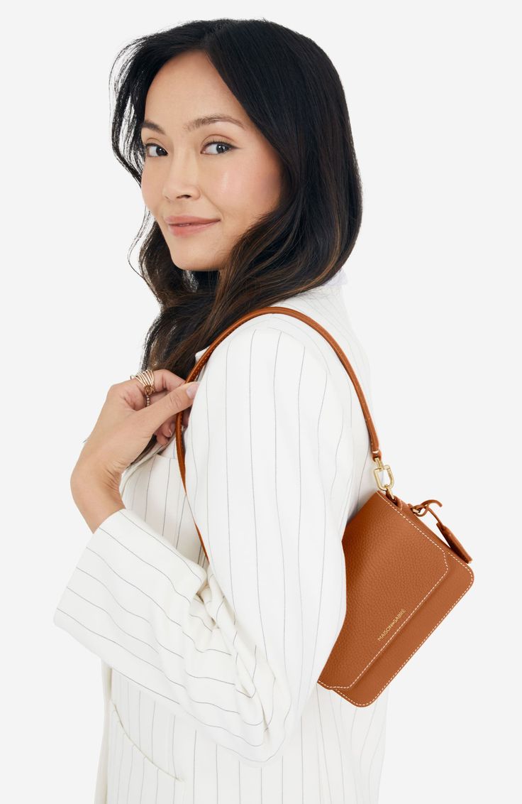 The ultimate all-occasion companion, the Mini Flap Bag is designed for day to night. Crafted from the world’s most sustainable full-grain European leather and measured to fit stadium sizing regulations, the ultra-sleek carryall secures with a full-coverage magnetic flap that extends over the front. Three unique storage compartments safeguard essentials while an adjustable strap unlocks multi-carry variations to help stamp your style on every corner of the globe. Detachable and adjustable strap ( Classic Phone Bag With Removable Pouch For Everyday, Versatile Brown Phone Bag For Travel, Classic Everyday Phone Bag With Removable Pouch, Versatile Brown Phone Bag With Removable Pouch, Brown Phone Bag With Detachable Strap For On-the-go, Brown Phone Bag With Detachable Strap For Travel, Brown Phone Bag With Detachable Strap For Everyday Use, Everyday Brown Phone Bag With Detachable Strap, Brown Phone Bag With Detachable Strap