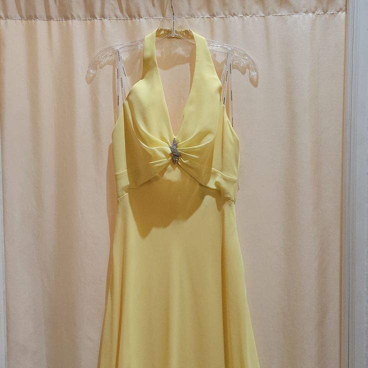 New Never Worn Yellow Halter Long A-Line Dress With Brooch On The Bodice Formal Fitted A-line Chiffon Dress, Elegant Flowy V-neck Halter Dress, Yellow Chiffon Prom Dress, Summer Formal Chiffon Dress With Fitted Bodice, Fitted Chiffon Dressy Dress, Formal Summer Chiffon Dress With Fitted Bodice, Fitted Chiffon Cocktail Dress, Dressy Fitted Chiffon Cocktail Dress, Fitted Chiffon Dress For Wedding