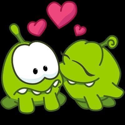 two green cartoon characters hugging each other with hearts floating above them on a black background