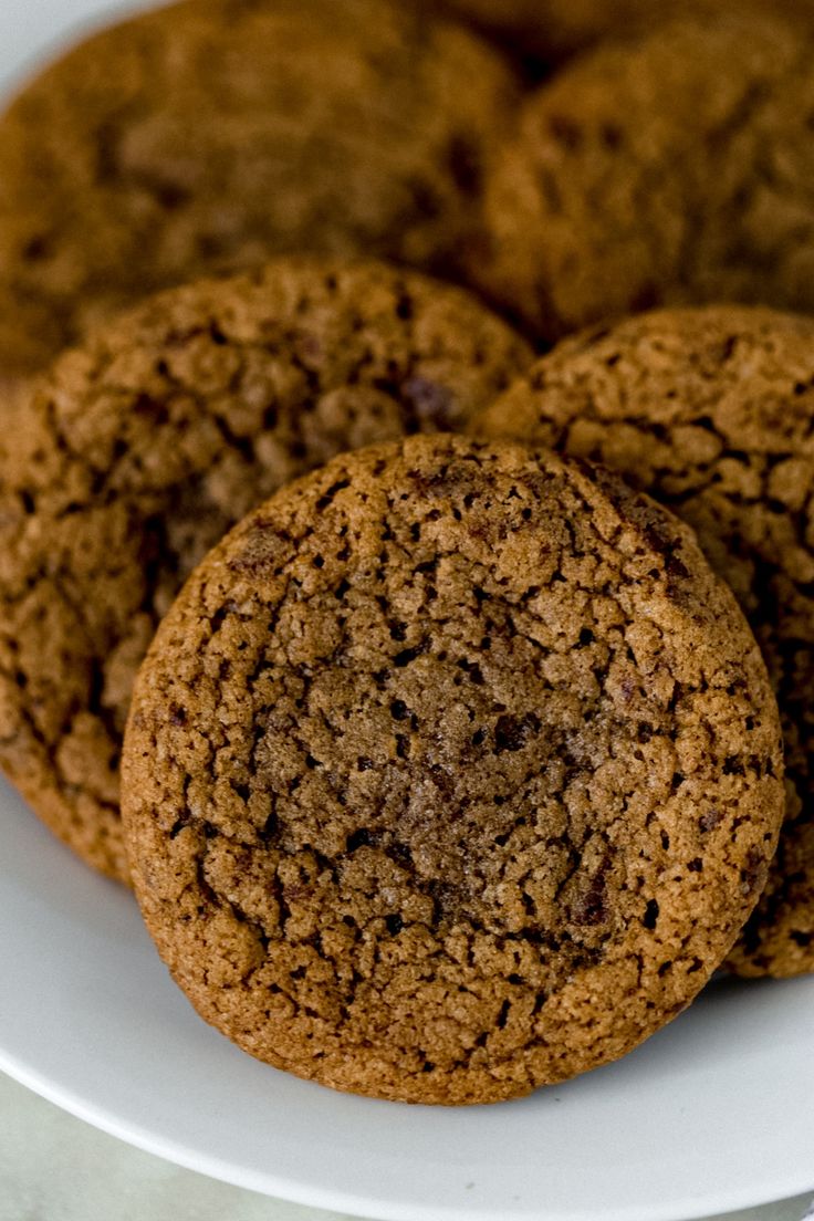 two chocolate cookies on a white plate with text overlay that reads easy coffee cookies