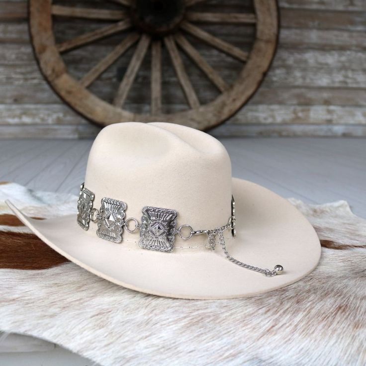 Add a bold, western touch to your hat with our Large Rectangle Concho Hat Band. Featuring silver-tone conchos measuring 1.75 inches high by 1.5 inches wide, this band fits most adult hat sizes and is adjustable for a perfect fit. Hat not included.     Color: Silver  Concho Dimensions: 1.75 inches high x 1.5 inches wide  Fits Most Adult Hat Sizes  Adjustable  *Hat not included*  CA Residents: Prop 65 Warning ↗️ Western Hat With Concho And Curved Brim, Western Hat With Concho And Flat Brim, Western Flat Brim Hat With Concho, Western Wide Brim Hat With Concho, Western Style Flat Brim Hat With Concho, Country Style Concho Hat Band For Rodeo, Western Style Concho Hats For Country Events, Southwestern Wide Brim Hat With Concho, Adjustable Western Felt Hat For Rodeo