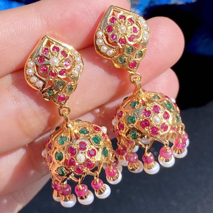 Featuring a small and light weight jadau jhumka for women made in sterling silver with gold plated. The jhumka has been studded with ruby like red stones, emerald like green stones and freshwater pearls. The studded stones comprise real rubies and freshwater pearls. The jhumka earrings close with a threaded bombay screw. Jadau Jhumka, Jadau Jwellery, 22k Gold Jewelry Necklaces, Desi Jewelry, Gold Jewellry, 22k Gold Jewelry, Like Green, Red Stones, Pearl Necklace Set