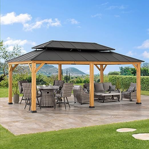 a gazebo with chairs and tables in the grass