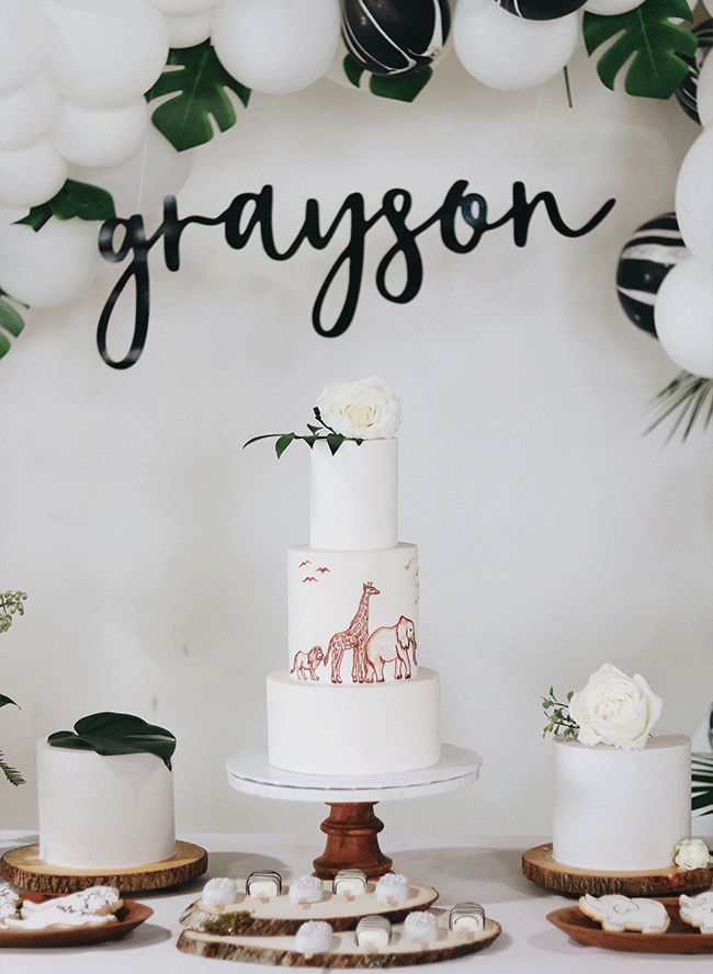 a white cake sitting on top of a table next to other cakes and desserts