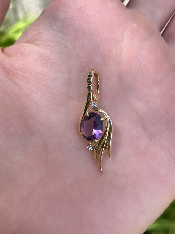 Total Weight: 2.8 grams Length: 32.9mm (including bail) Width: 11.4mm Amethyst: 8.7x7mm Diamonds: 1.4mm Condition: In great condition showing little wear with no damage. All gold has been thoroughly checked with an Olympus XRF spectrometer. Guaranteed 14k gold.  All our jewelry is properly washed and disinfected to ensure customers get clean items with every order.  Returns accepted but may be subjected to a restock fee.  Please message with any questions:) Purple 14k Gold Round Pendant Jewelry, 14k Gold Round Purple Pendant Jewelry, 14k Gold Purple Round Pendant Jewelry, Amethyst Gemstones In Yellow Gold With Prong Setting, Amethyst Gemstones In Prong Setting - Yellow Gold, Purple Oval 14k Stamped Jewelry, Yellow Gold Amethyst Jewelry With Prong Setting, Amethyst Oval Pendant Jewelry For Anniversary, Amethyst Yellow Gold Jewelry Stamped 14k