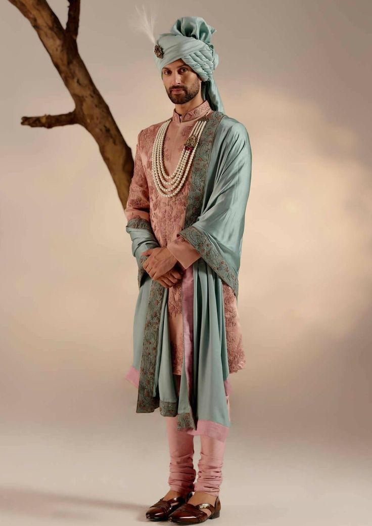 Featuring our work of art in orchid pink sherwani with intricate hand embroidery details using shades of pink and zari. Paired with a chateau grey hand-embroidered stole and safa. Pink Traditional Churidar For Transitional Season, Transitional Pink Churidar With Traditional Drape, Pink Traditional Naqshi Sherwani, Pink Sherwani With Intricate Embroidery, Pink Raw Silk Sherwani With Traditional Drape, Designer Pink Sherwani Straight Kurta, Pink Sherwani With Resham Embroidery In Traditional Drape, Pink Embroidered Sherwani For Eid, Pink Embroidered Sherwani Straight Kurta