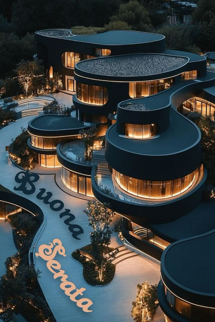 an aerial view of a building at night with lights shining on the facade and circular windows