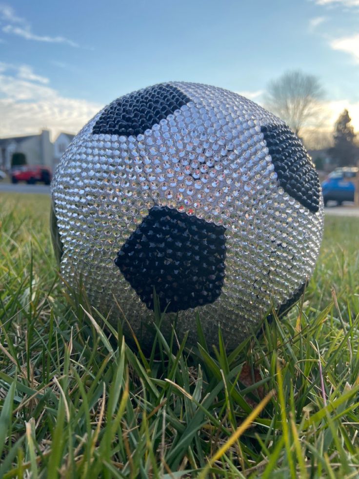 a close up of a soccer ball in the grass