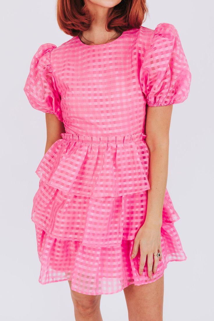 The Pinky Swear Dress is full of fun and quirky features to make you stand out! Puffy sleeves, tiered layers, and a ruffle waist detail add whimsy, while a mesh overlay adds texture. Trust us, you'll be making a pinky swear to never take this dress off. Details Puffy sleeves Tiered Ruffle waist detail Mesh overlay Fully lined Sizing Approximate measurements: SIZE LENGTH BUST Small 35"﻿ 34"﻿ Medium 36"﻿ 36"﻿ Large 36"﻿ 38"﻿ Fabric has no stretchModel is 5’10 wearing small Material 100% PolyesterH Ruffled Bubble Hem Dress For Brunch, Ruffled Bubble Hem Brunch Dresses, Fitted Tiered Puff Sleeve Dress With Ruffles, Pink Flirty Puff Sleeve Dress With Ruffles, Pink Mini Tiered Ruffled Dress, Pink Mini Tiered Dress With Ruffled Skirt, Flirty Pink Puff Sleeve Dress With Ruffles, Pink Ruffled Mini Length Tiered Dress, Spring Party Mini Dress With Layers