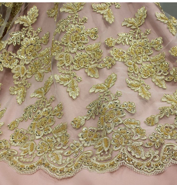 This beautiful Beaded & Corded lace fabric is perfect for weddings, quinceanera dresses, evening gowns, and more. The fabric is 100% polyester and is embroidered with elegant beads, pearls, and sequins to make a truly unique masterpiece. This handcrafted Beaded & Corded lace fabric is perfect for any special occasion, offering an unrivaled elegance that will look perfect for any bridal or couture gowns. The beaded and corded lace fabric is available in 4 beautiful colors, making it the perfect p Quinceanera Gown With Intricate Embroidery, Fitted Dresses With Intricate Embroidery For Quinceanera, Fitted Floral Embroidery Gown For Quinceanera, Fitted Floral Embroidered Gown For Quinceanera, Fitted Gown With Floral Embroidery For Quinceanera, Floor-length Gown With Intricate Embroidery For Quinceanera, Embroidered Floor-length Gown For Quinceanera, Elegant Embroidered Quinceanera Gown, Gold Embellished Dress For Quinceanera