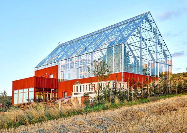 a large red building with a glass roof on the top of it's side