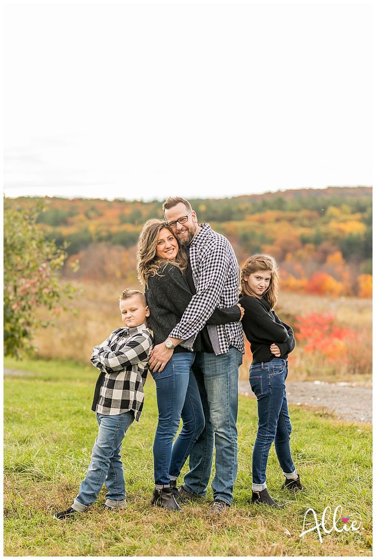 a family posing for a photo in an open field