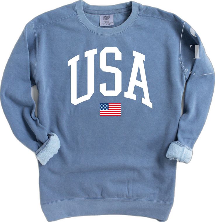 Patriotic Blue Tops For Fall, Cotton Long Sleeve Top For 4th Of July, Long Sleeve Cotton Tops For 4th Of July, Casual American Flag Sweater For 4th Of July, Casual Long Sleeve T-shirt With Flag Print, Sporty Crew Neck Top With American Flag Print, Cotton Varsity Crew Neck Top, Cotton Varsity Crew Top, Casual Long Sleeve Sweater For 4th Of July