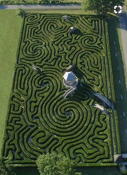 an aerial view of a large maze in the grass