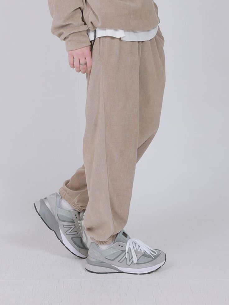 Editor's NotesThese jogger pants feature light and thick cotton-polyester blended fabric  waist banding with drawstring. It can be styled in various ways. For unisex.- Waffle texture of light and thick cotton-polyester blended fabric- Warm and soft- Waist banding with drawstring- Side and back pockets - Loose fitMeasurements (in.)M / L- Total length: 38.19 in. / 39.76 in.- Waist: 14.17 in. / 15.35 in.- Thigh: 12.20 in. / 12.99 in.- Rise: 9.84 in. / 10.63 in.- Hem: 5.51 in. / Beige Athleisure Sweatpants For Streetwear, Relaxed Fit Beige Sweatpants With Pockets, Beige Relaxed Fit Sweatpants With Pockets, Casual Beige Bottoms With Ribbed Waistband, Casual Beige Sweatpants For Winter, Sporty Beige Sweatpants For Streetwear, Beige Cotton Joggers With Elastic Waistband, Casual Beige Cotton Joggers, Beige Athleisure Sweatpants With Elastic Waistband