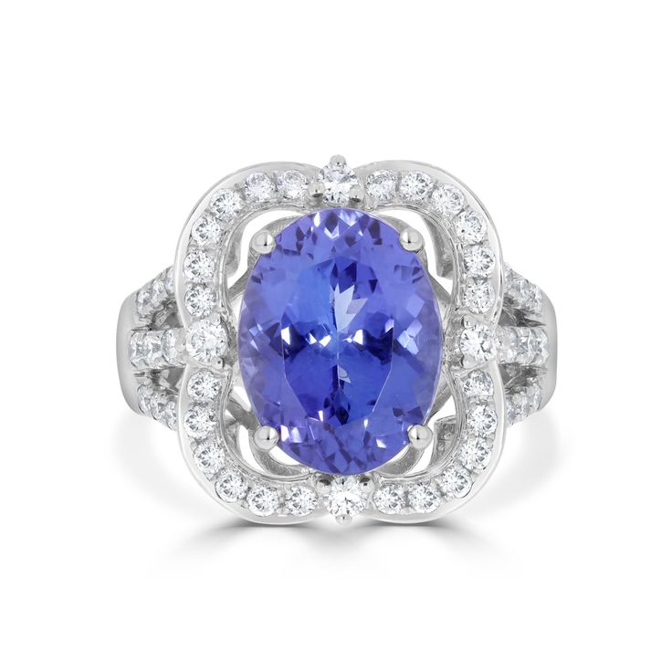 13x10 Violetish Blue AAAA Tanzanite Ring Oval shape 6.40 ct with 0.85 cttw Diamond in 14K White Gold. Product Information SKU TT1010/3 Metal Type 14K Metal Color White Gold Ring Style - Primary Stone Gemstone Name Tanzanite Gemstone Species Zoisite No. of Gemstones 1 Gemstone Grades AAAA Gemstone Shape Oval Gemstone Weight 6.40 Gemstone Size 13x10 Origin Tanzania Secondary Stone Gemstone Name Diamond Gemstone Species Diamond No. of Gemstones 46 Gemstone Grades - Gemstone Shape Round Gemstone Wei Oval Gemstones With Halo Setting For Formal Occasions, Classic Oval Gemstones With Halo Setting, Oval Tanzanite Diamond Ring For Formal Occasions, Formal Tanzanite Diamond Ring, Oval Shape, Formal Tanzanite Diamond Ring Oval Shape, Formal Oval Tanzanite Diamond Ring, Oval Tanzanite Diamond Ring In White Gold, Gia Certified Oval Tanzanite Diamond Ring, Formal Tanzanite Pear-shaped Ring