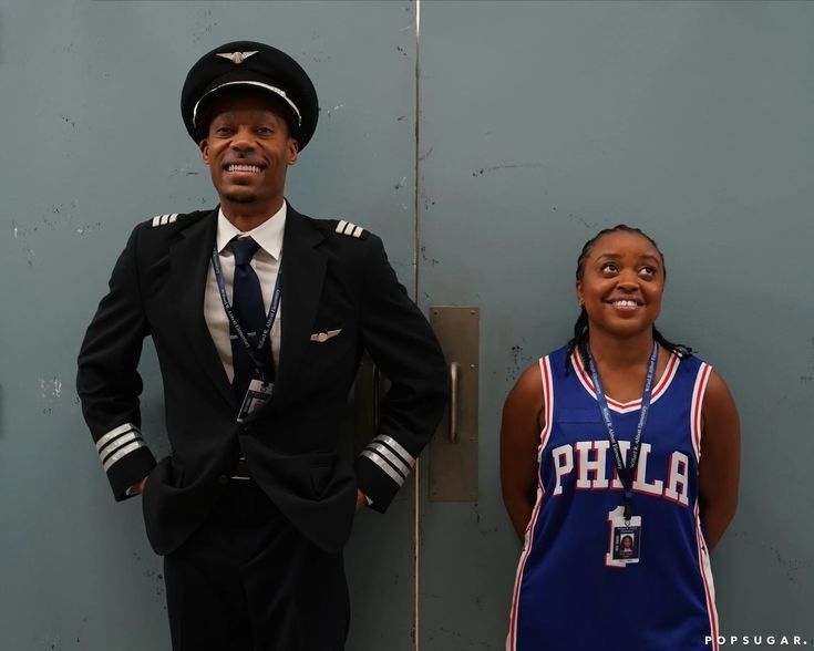 a man in uniform standing next to a woman