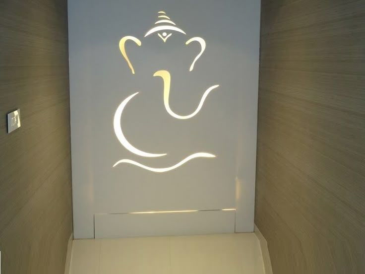 a white toilet sitting in a bathroom next to a wall with an elephant drawn on it