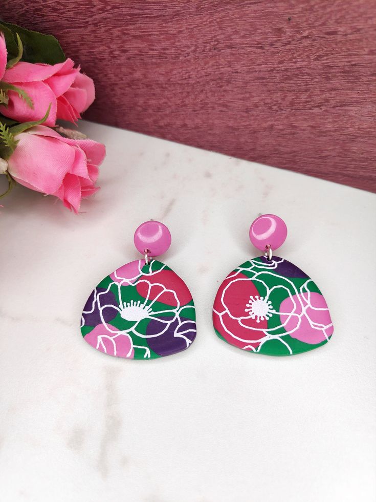 Dazzle your ears with these beautiful green and pink earrings, meticulously handcrafted from polymer clay and adorned with a stunning floral motif.  Add this exquisite combination of green and pink to your collection, guaranteed to elevate your look with a touch of subtle charm. Dimensions ♥︎ Length 39 mm/ 1.53 inch ♥︎ Overall width 30 mm / 1.18 inch Enter a world of endless creativity with unique jewelry from my creations. They are made of polymer modeling clay! Each piece is made with love and Hand Painted Green Flower Earrings, Green Hand Painted Flower Earrings, Hand Painted Pink Flower Jewelry, Pink Hand Painted Flower Jewelry, Green Polymer Clay Flower Drop Earrings, Pink Polymer Clay Flower Earrings For Gift, Handmade Pink Polymer Clay Flower Earrings, Pink Hand-painted Polymer Clay Jewelry, Hand Painted Pink Polymer Clay Jewelry