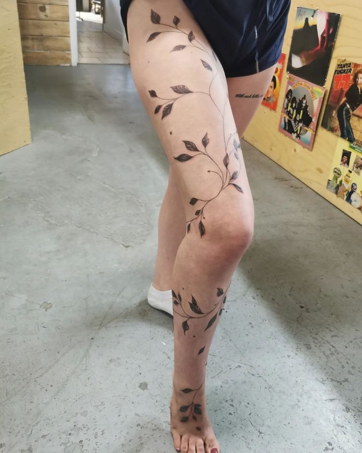 a woman's legs with tattoos on them