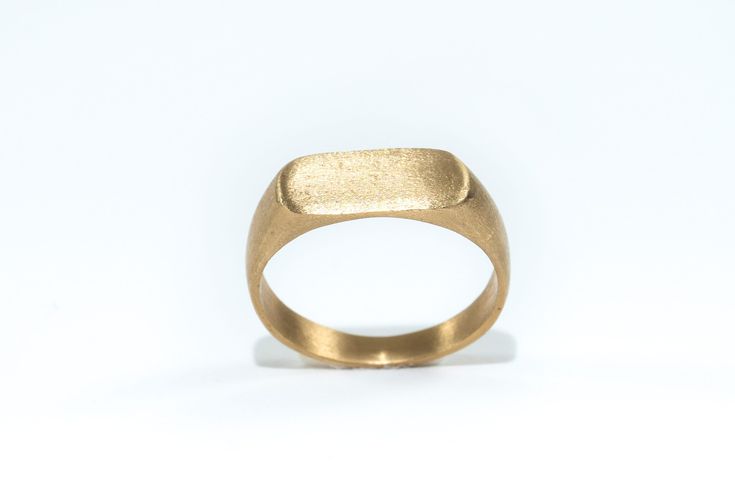 "Classic style handmade Signet 9k Gold Ring For Women or Men When the seal is made of K9 gold with brushed polishing in a matte shade. The ring is classic, has clean lines, and is light and comfortable to wear  ITEM DETAILS: Made of 9k solid Gold. The size of the rectangle pattern: 0.27/0.59\" ( 1.5/0.7 cm). Size in stock: 6,7,8,9 Size in photo US7 ✦ Gift box ✦ Ready to ship See more wedding rings in my shop: https://www.etsy.com/il-en/shop/batyas?ref=hdr_shop_menu§ion_id=21111855 Back to my shop: https://www.etsy.com/shop/batyas?ref=si_shop Thank you for stopping by, and have a great day :) JEWELRY CARE - Some important notes All jewelry needs special care - whether it is solid gold or silver, or metal plating. To Protect Overtime: * Avoid wearing jewelry while sleeping, working, or exerc Minimalist Gold Signet Ring In Recycled Gold, Modern Wedding Signet Ring With Smooth Bezel, Modern Gold Brass Signet Ring, Minimalist Engraved Gold Ring In Recycled Gold, Minimalist Brass Rings For Formal Occasions, Gold Wedding Rings With Smooth Finish, Everyday Gold Signet Ring With Smooth Bezel, Minimalist Gold Signet Ring In Brass, Minimalist Gold Brass Signet Ring