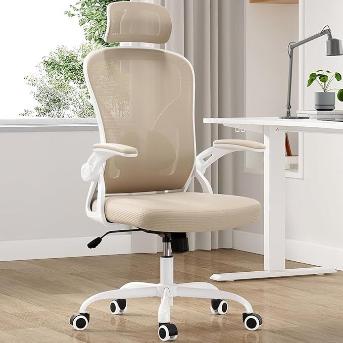 a white office chair sitting in front of a desk with a plant on top of it