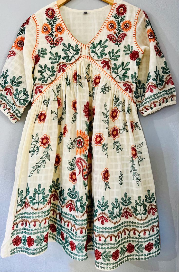 This Beautiful Floral embroidered Short Dress is the perfect dress to add to your wardrobe. The dress features intricate and colorful floral embroidery. The design can fully show your feminine charm. This Women's summer dress is suitable for many occasion, casual daily wearing, shopping, party, working, beach, wedding, and so on. Also you can give this dress to your family as a birthday present or souvenir. Available Sizes are US (S,M,L) Ship From US Spring Cotton Dress With Floral Embroidery, Folk Style Dresses With Resham Embroidery, Folk Dresses With Multicolor Resham Embroidery, Cream Short Sleeve Dress With Floral Embroidery, Traditional Off White Dress With Resham Embroidery, Spring Cotton Embroidered Dress For Garden Party, Multicolor Embroidered Dress For Summer Festivals, Embroidered Cream Dress For Garden Party, Traditional Cotton Dress With Multicolor Embroidery