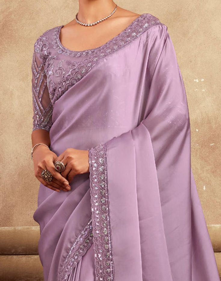 COLOR : Mauve FABRIC : Saree - Satin Silk, Blouse - Satin Silk & Net WORK : Resham Embroidery, Stones, Sequins, Lace BorderOCCASION : Wedding, Engagement, Party Wear, Festival, Sangeet NOTE : The outfit includes blouse and saree only. Petticoat is not included. READY-TO-WEAR : No STITCHING : Available as semi-stitched fabric, can be stitched using standard size option (+$30). Note: There might be a slight color variation due to lighting and flash used during photoshoot. The bright shade seen is