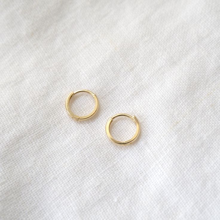 The perfect classic hoop! You can wear these solid 14k hoops as your every day pair, stack them up your lobe, or use them as the back drop for your favorite charm! Comes in sizes 10mm, 12mm, 15mm and 20 mm in diameter, and are 1.5mm thick. Sold as singles - purchase two for a pair! Classic Small Hoop Yellow Gold Cartilage Earrings, Classic Yellow Gold Small Hoop Cartilage Earrings, Small 14k Gold Stackable Hoop Earrings, 14k Gold Small Hoop Stackable Earrings, Small Yellow Gold Stackable Hoop Earrings, Classic Stackable Hoop Huggie Earrings, Classic Small Hoop Stackable Huggie Earrings, Classic Small Hoop Stackable Earrings, Classic 14k Gold Hoop Cartilage Earrings