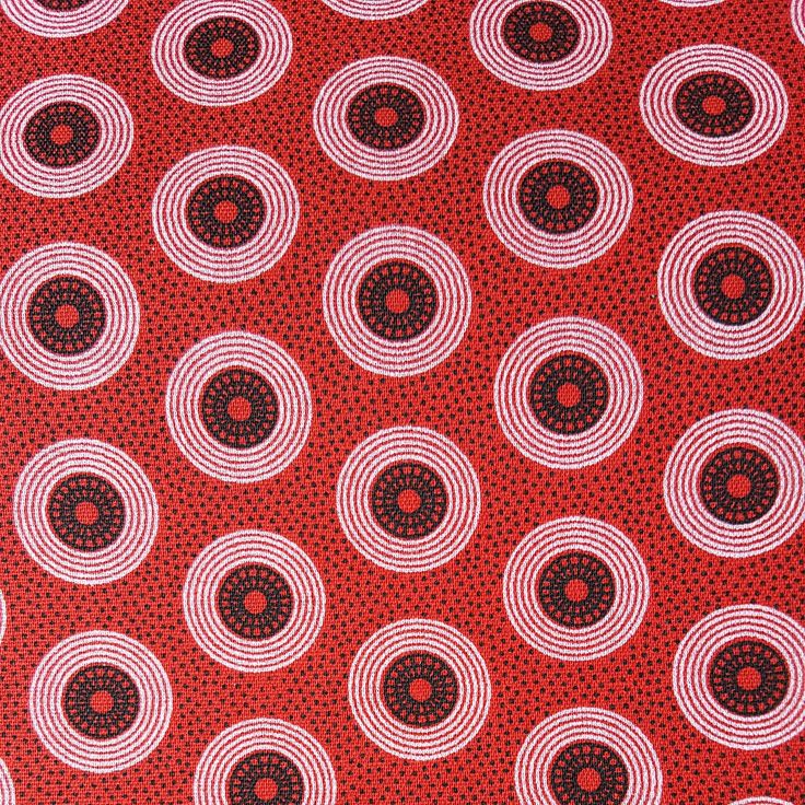 a red tie with black and white circles on it