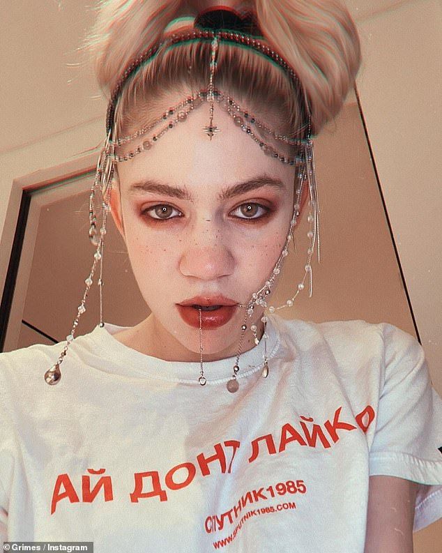 a woman with chains on her head is wearing a t - shirt