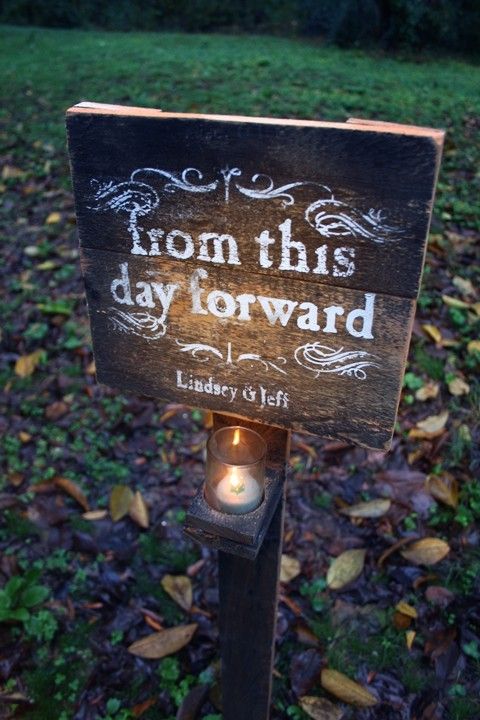 a wooden sign that says, from this day forward library of life on it's post