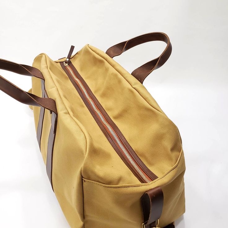 "This Travel Bag is made from 18 oz harvest tan canvas with brown leather trims. SIZE: 20\" wide x 13\" Tall x 11\" depth Features: 2\" adjustable cross bodyt strap (Removable) 2 sides handles Inside zipper pocket 9\"x10\" Metal tooth zipper for long lasting use Stitched with nylon tread for durability. ♡ PROCESSING TIME: Your travel bag will ship within 1-3 business day after purchase. ♡ SHIPPING TIME: 2-5 business days within the US via UPS. ♡ GIFTS: You can ship our products directly to your Large Capacity Khaki Canvas Travel Bag, Khaki Rectangular Canvas Travel Bag, Khaki Canvas Travel Bag For Everyday Use, Everyday Use Khaki Canvas Travel Bag, Large Capacity Brown Canvas Bag, Rectangular Coated Canvas Bag For Everyday Carry, Brown Large Capacity Bag For Everyday Carry, Canvas Khaki Duffle Bag For Everyday, Khaki Canvas Travel Bag