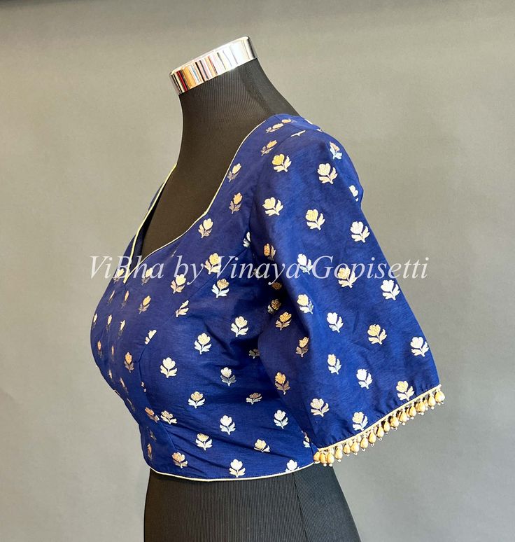 This beautiful dress is crafted from luxurious Benares silk and features hand-beaded detail along the hemline of the silky smooth sleeves. The perfect choice for any special occasion. Traditional Embellished Blue Blouse, Festive Blue Embellished Blouse, Festive Embellished Blue Blouse, Elegant Embellished Blue Blouse Piece, Fitted Blue Blouse Piece For Reception, Blue Floral Embroidery Blouse Piece For Party, Blue Floral Embroidery Blouse For Party, Blue Blouse Piece With Floral Embroidery For Party, Blue Party Blouse With Floral Embroidery