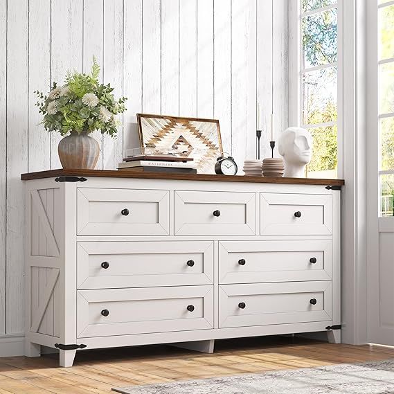 a white dresser with drawers and vases on top