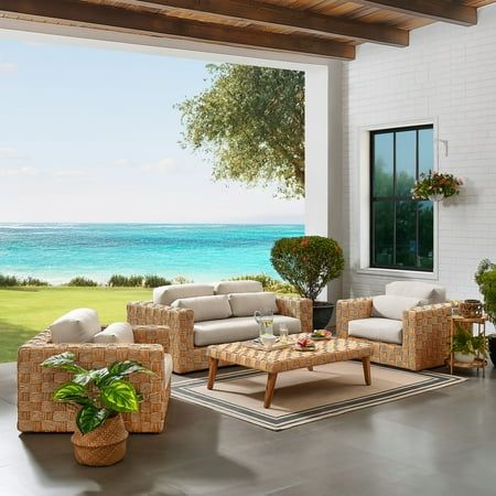 a living room filled with furniture next to the ocean