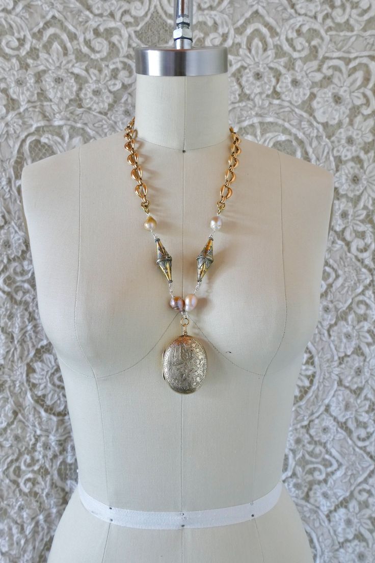 This beautiful necklace is made from large vintage mid century gold filled locket from Thailand. It is set with freshwater baroque pearls, vintage Turkmen beads, and mid century gold filled hollow formed chain. All these pieces come together to make a lovely mixed metal necklace with heirloom appeal.  All pieces are unique. They are made completely from found and recycled parts, much like found-object art. I have loved jewelry my whole life. I want to create pieces that drape and lay on the body the way clothing would, using relics and totems from years past. Jewelry you'd see a rockstar wear... Jewelry that requires guts, soul, and thought... www.reckless-daughter.com Unique Gold Necklaces From Vintage Collection, Unique Gold Vintage Necklace, Unique Gold Jewelry For Vintage Events, Gold Pearl Necklace For Wedding, Unique Gold Pearl Necklace For Wedding, Gold Pearl Wedding Necklace, Unique Gold Pearl Wedding Necklace, Gold Medallion Jewelry For Vintage Events, Gold Necklace With Pearl Charm