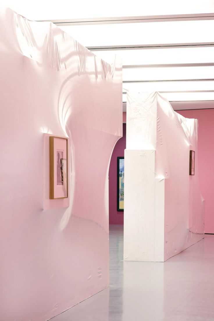 a room with pink walls and white columns