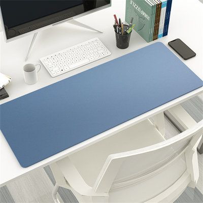 a computer desk with a blue mat on it