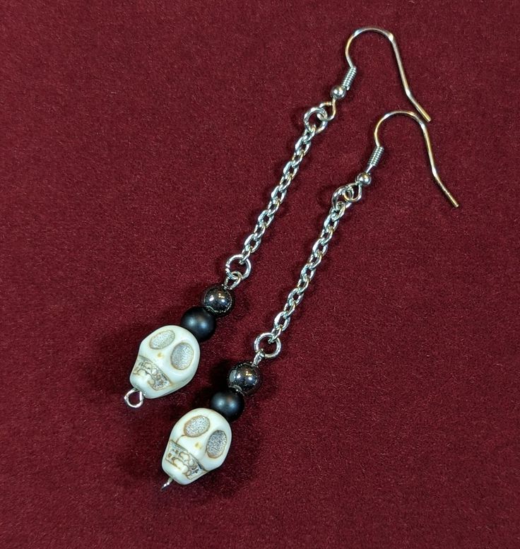 Dangle skull bead earrings. Hangs on a stainless steel chain, with a stainless steel earring hook. Dangle length is 2 1/2 inches, but can be adjusted to any length. If you would like a customized length, please message me or leave a note in your order. Edgy Nickel-free Skull Earrings, Edgy Handmade Dangle Earrings, Handmade Edgy Dangle Earrings, Punk Hypoallergenic Dangle Jewelry, Hypoallergenic Punk Dangle Jewelry, Handmade Punk Dangle Jewelry, Handmade Punk Style Dangle Jewelry, Edgy Nickel-free Skull Jewelry, Edgy Pierced Skull Jewelry