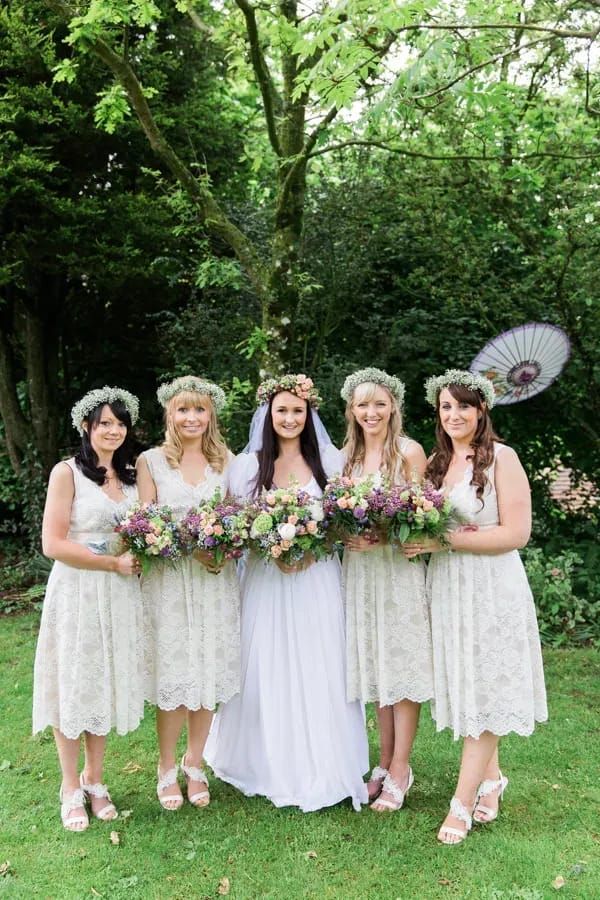 a group of women standing next to each other on top of a lush green field