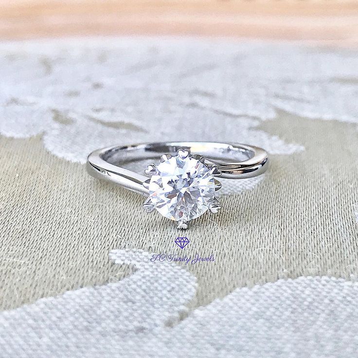 This pretty bypass solitaire ring is set with an excellent brilliant cut "hearts and arrows" D colorless Moissanite. Moissanites have become very popular. It is desired and preferred over a Diamond for it's sparkle and cost. As specified below this description the refractive index is a little higher on a Moissanite than on a Diamond. The lower cost of a Moissanite ring means you can wear it everyday, go anywhere you want to go with it and never fear losing lots of money should it get lost or sto Gia Certified Heart Cut Diamond Anniversary Ring, Gia Certified Lab-grown Diamond Promise Ring, Gia Certified Heart Cut Diamond Ring, Heart Cut Lab-grown Diamond Ring With Diamond Cut, Lab Grown Diamond Heart Cut Ring For Anniversary, Gia Certified Moissanite Round Band Ring, Heart Cut Moissanite Diamond Ring With Prong Setting, Anniversary Heart Cut Lab Grown Diamond Ring, Heart Cut Lab Grown Diamond Ring For Anniversary