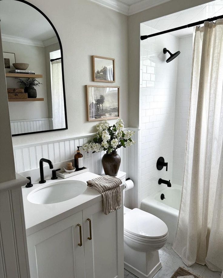 a bathroom with a sink, toilet and shower in it's center piece is shown