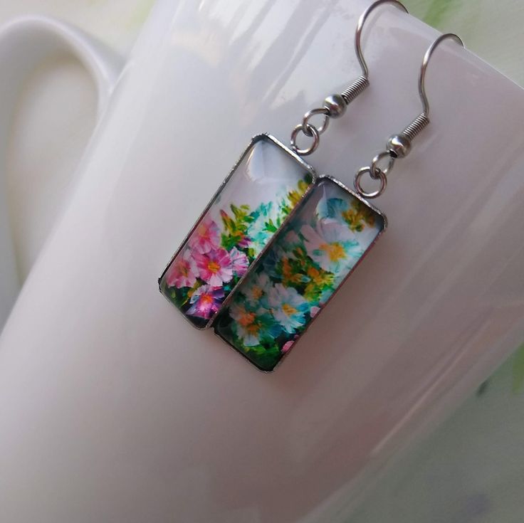 Vibrant Flowers Art Pattern Painting Handmade Glass Jewelry Hook Earrings Artistic bold statement earrings, a perfect gift and choice for any occasion. Ideal gift for an artist. Chic and Unique. Measures 25 mm in length and 10 mm in width. Comes with First Class Free shipping. Colors may vary due to monitor and lighting differences. Artistic Flower-shaped Earrings For Gifts, Artistic Drop Flower Earrings As Gift, Artistic Flower Drop Earrings For Gift, Colorful Hand Painted Earrings As Gift, Artistic Multicolor Flower Drop Earrings, Colorful Hand Painted Earrings For Gift, Colorful Drop Earrings As A Gift, Hand Painted Rectangular Earrings Gift, Hand Painted Colorful Earrings For Gifts