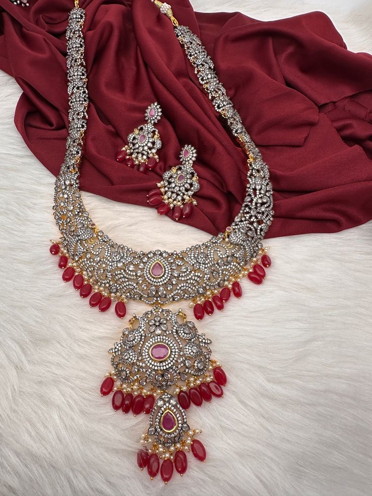 AD Red Stone Red Beads Dual Polish Long Necklace with screw back  earrings Victorian finish gives diamond look to the necklace. Fine quality and craftmanship. Premium quality. Ideal for desi weddings, House warmings baby showers. It has an adjustable cord(dore) back thread hence can adjust length. Necklace Length : 24 Inches Approx. Earring Length : 2 inches; Screw Back Ready to ship from Massachusetts, USA If you have any questions please let me know. Red Stone Jewelry For Wedding, Red Diamond Necklace For Festive Occasions, Traditional Red Jewelry Sets For Wedding, Red Hand Set Necklaces For Anniversary, Ruby Jeweled Necklaces For Wedding, Red Temple Jewelry For Anniversary, Red Diamond Jewelry For Wedding, Celebration Bridal Necklace With Red Diamond, Red Diamond Wedding Jewelry