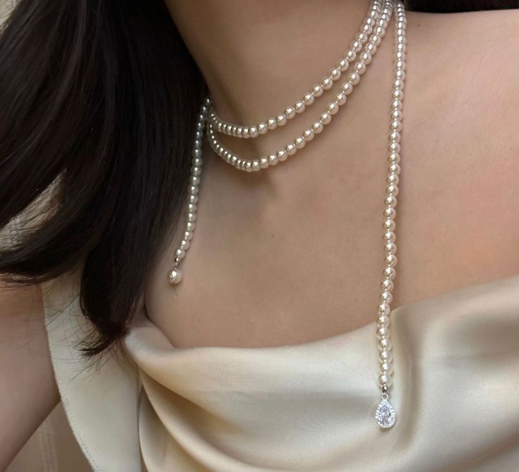 Discover the timeless elegance of our 50-inch Swarovski pearl necklace, a masterpiece of classic beauty and versatility. Crafted with premium 6mm Swarovski pearls, this exquisite strand offers a luxurious touch with endless styling possibilities. Wear it long for a graceful, flowing look, double it for a sophisticated layered effect, or knot it for a modern twist. Perfect as a thoughtful anniversary gift or a versatile addition to any jewelry collection, this necklace invites you to experiment w Stacking Necklace, Long Pearl Necklace, Swarovski Pearl Necklace, Layered Pearl Necklace, Pearl Necklace Designs, Long Pearl Necklaces, Stacked Necklaces, Doll Jewelry, Swarovski Pearls