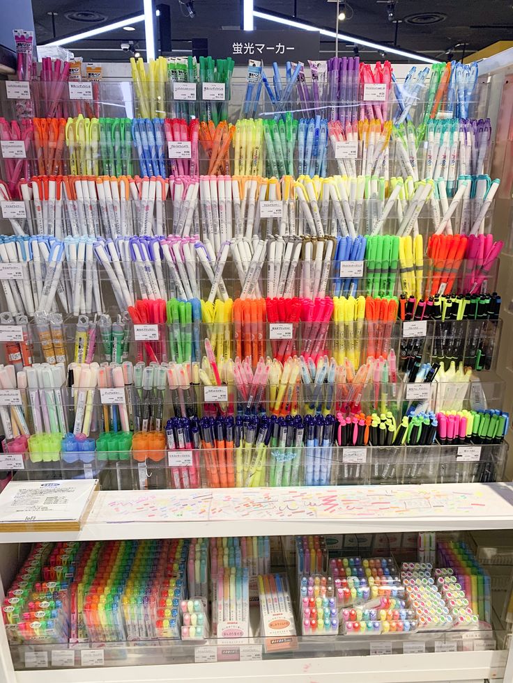 there are many different colored toothbrushes on the shelves in this store, and one is for sale